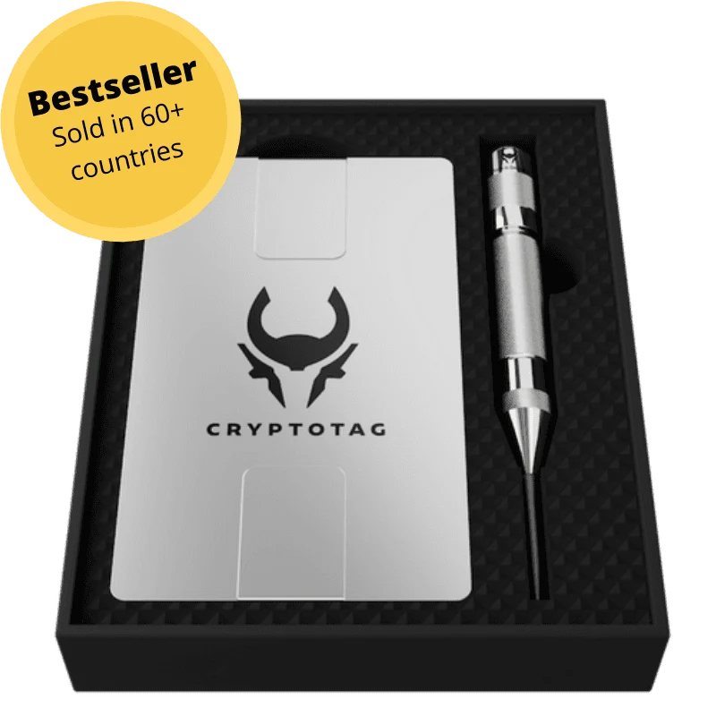 Cryptotag titanium plate in its black presentation box next to a center punch, with a yellow Bestseller, sold in 60+ countries badge